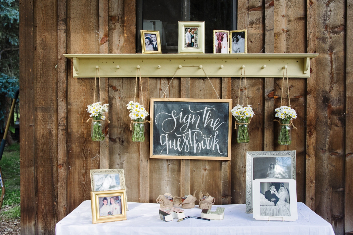 - AMY ROCHELLE PRESS - Sign the Guestbook Chalk Board Sign with wild picked daisies from the river. Photo by Images by Bethany